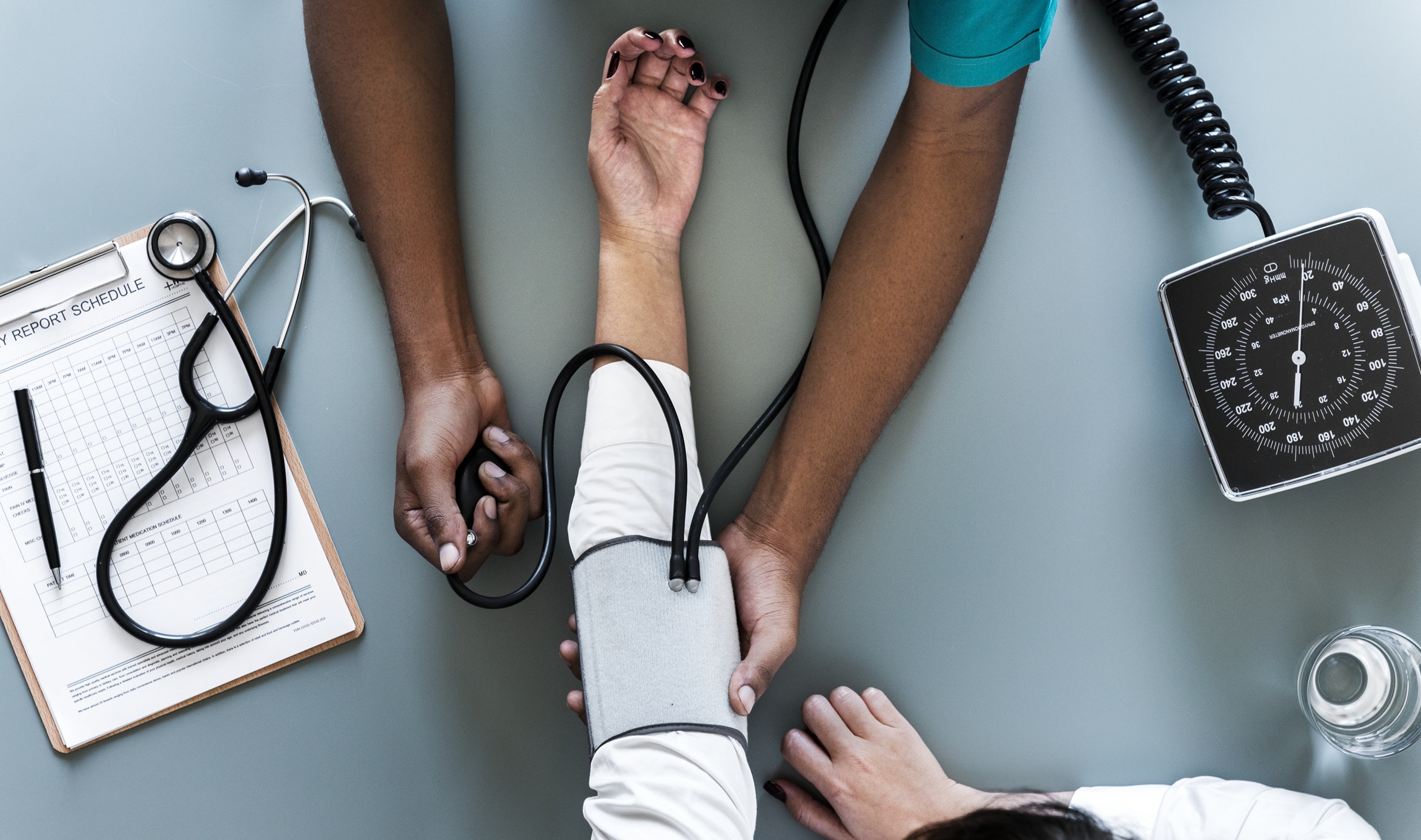 Doctor checking blood pressure